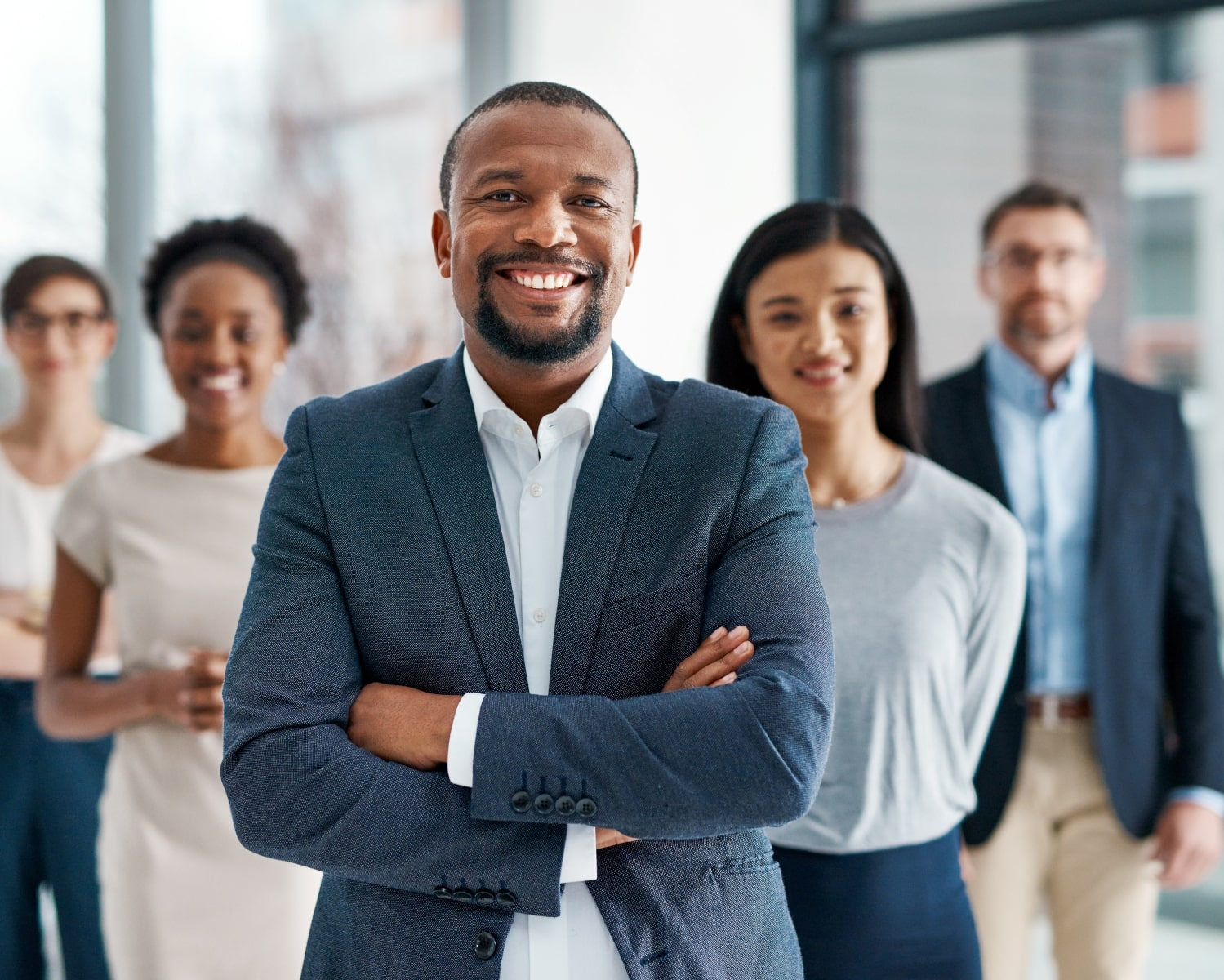 Business leader standing with a diverse professional team